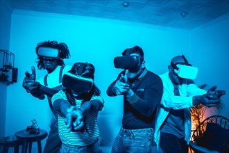 Group of young people with vr glasses in a virtual reality game in a blue light
