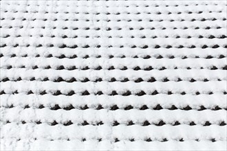 Snowy roof tiles on a roof in winter