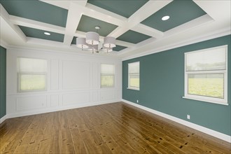 Beautiful muted teal custom master bedroom complete with entire wainscoting wall