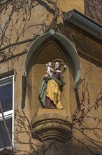 Religious sculpture on a residential house in the Jakob Fugger Siedlung
