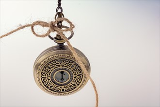 Retro style pocket watch in hand on white background