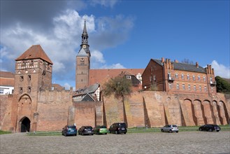 Historic town wall with defence defence tower and St. Stephens Church