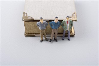 Tiny figurine of men models found beside a book