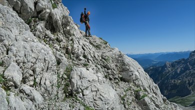 Tourist with equipment on the via ferrata trail in the alps. Zugspitze massif