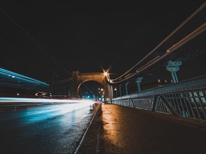 Bridge at night with vehicles light trails