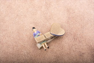 Woman figurine trapped in a clothespin on ground