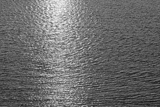 Sea surface with small waves and light reflections