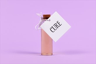 Cure in glass vial with label on violet background