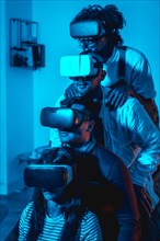 Group of young people with vr glasses in a virtual reality game in a blue light