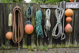 Old ropes and buoys on a fence