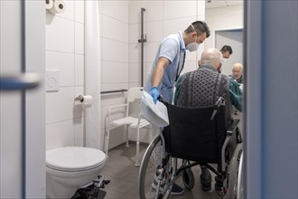 Caregiver with old man in nursing home