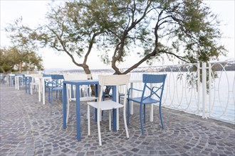 Tables and chairs of a cafe by the sea