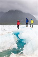 Hikers on the Exploradores glacier in the San Valentin massif
