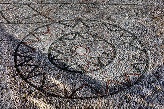 Pebble mosaic in front of the cross-domed church of Kimissis tis Theotokou