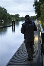 Anglers on the Giselau Canal in rainy weather