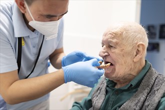 Geriatric nurse sets old mans dentures