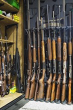 Stored collection of hunting rifles and ammunition in safe keeping gun cabinet