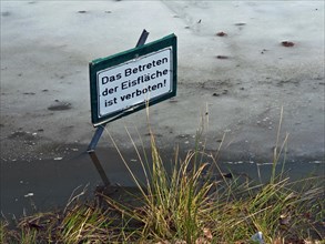 Warning sign in a pond