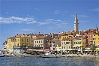Waterfront showing boats and sailing ship in harbour of the city Rovinj