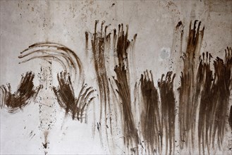 Handprints are seen on a wall of a house in Schuld