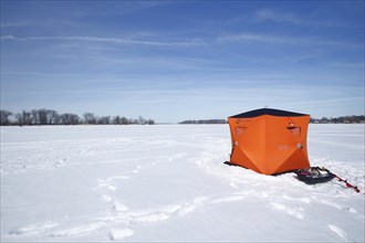 Icefishing cabin on the frozen river