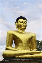 Golden Buddha statue in Viharamahadevi Park in the centre of Colombo