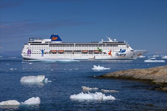 The Grand Mistral cruise ship among icebergs in the Kangia Icefjord