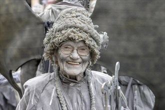 Older smiling woman in grey
