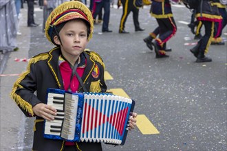 A masked boy with an accordion at the carnival in Rijeka