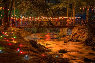 Colourful tea lights by the river for the Festival of Lights