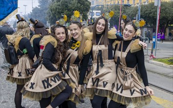 Four smiling girls masked in clock dresses at the carnival in the city of Rijeka