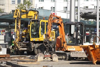 Construction vehicles on a building site during road works
