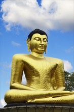 Golden Buddha statue in Viharamahadevi Park in the centre of Colombo