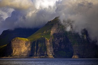 The Faroe Island of Kalsoy in the Atlantic Ocean with Sun and Clouds
