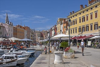 Tourists wandering in the harbour of the city Rovinj
