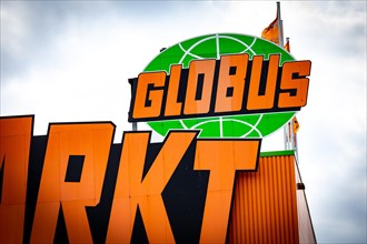 The sign of a Globus DIY store in a commercial area in Berlin