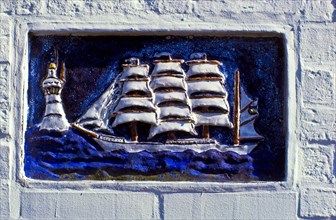 Relief panel of a sailing ship on a house wall on the island of Spiekeroog