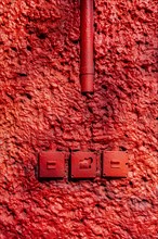 Red wall with old light switches