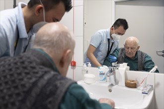 Caregiver and old man in a nursing home
