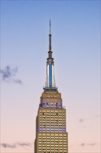 Empire State Building glows white-blue