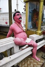 Brahmin plaster sculpture in front of Hindu temple