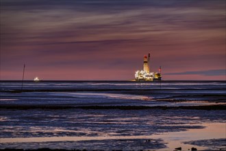 Germanys only oil rig Mittelplate at night and low tide