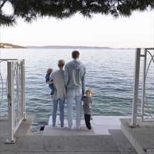Family standing by the sea