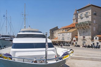 Yachts moored along promenade at harbour of the historic Old Town of Trogir along the Adriatic Sea