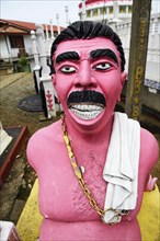 Brahmin plaster sculpture in front of Hindu temple