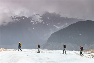 Hikers on the Exploradores glacier in the San Valentin massif