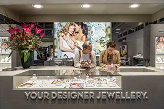 Women in a sales talk at a showcase with high quality designer jewellery