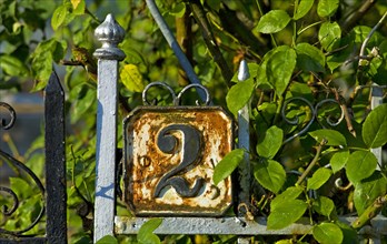 House number 2 on an old fence