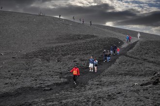 Hikers in the volcanic landscape of Etna