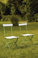 Two garden chairs on a lawn